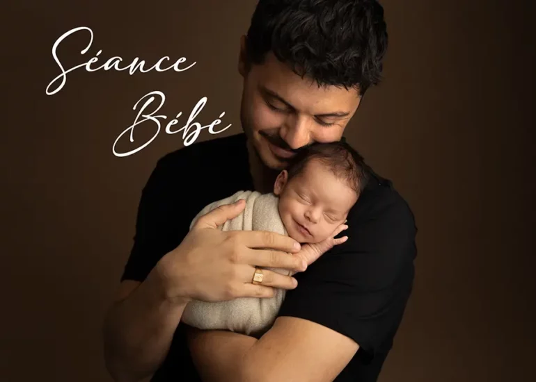 photo d'un papa avec son bébé dans les bras.